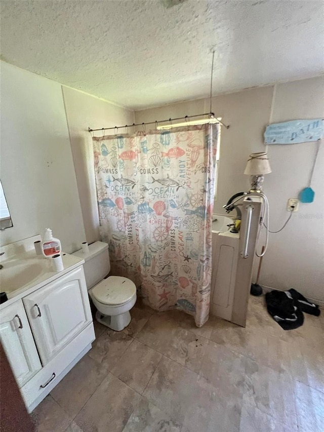 bathroom featuring a shower with curtain, vanity, toilet, and a textured ceiling