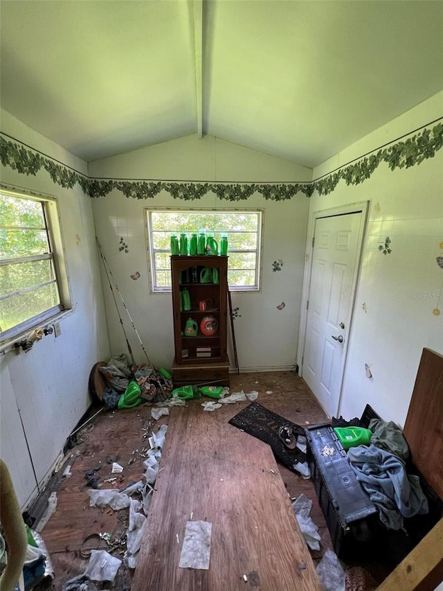 miscellaneous room with hardwood / wood-style floors, vaulted ceiling with beams, and a wealth of natural light