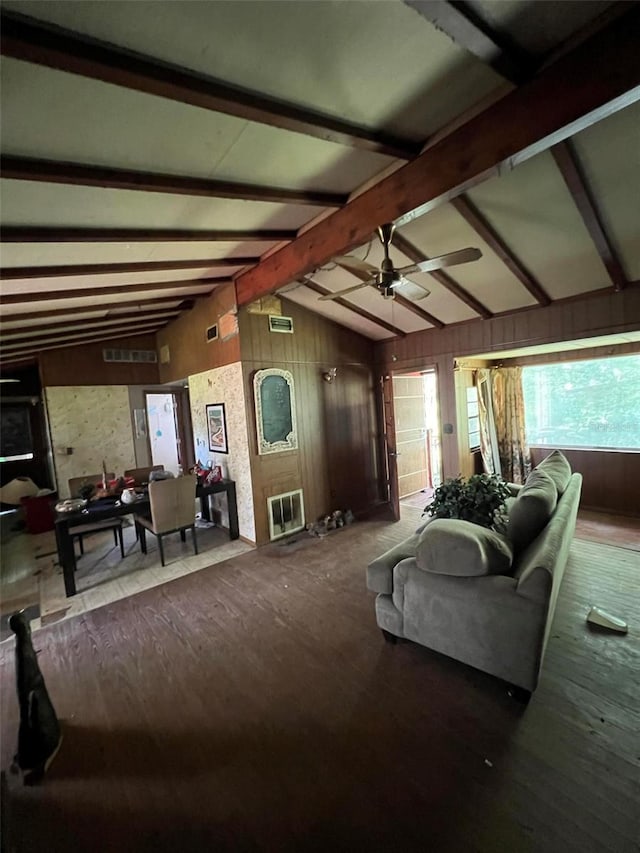 living room with ceiling fan, hardwood / wood-style floors, lofted ceiling with beams, and wooden walls