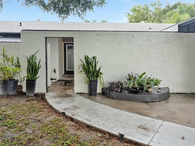 view of exterior entry featuring a patio