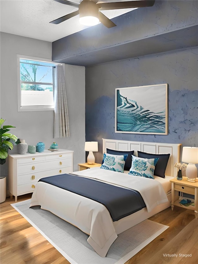 bedroom with ceiling fan and light wood-type flooring