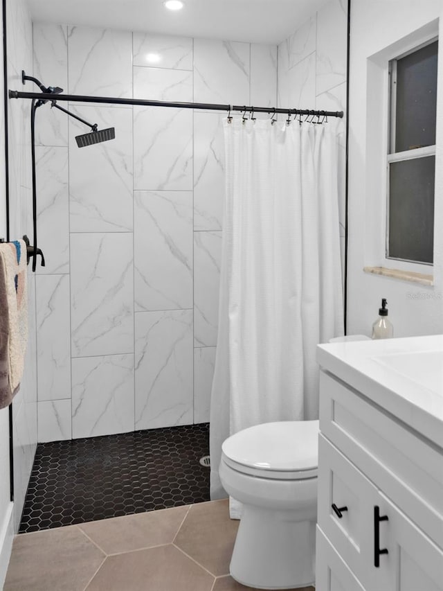 bathroom with tile patterned flooring, toilet, vanity, and a shower with curtain