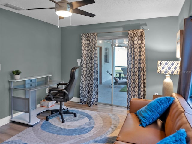 office space featuring ceiling fan and hardwood / wood-style flooring