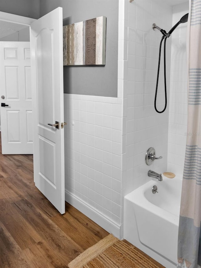 bathroom with shower / tub combo and hardwood / wood-style floors