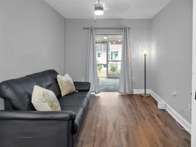 living room featuring ceiling fan and hardwood / wood-style floors