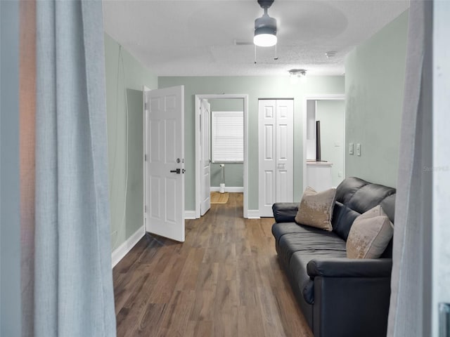 living room featuring hardwood / wood-style flooring and ceiling fan