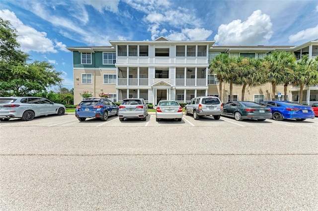 view of building exterior featuring uncovered parking