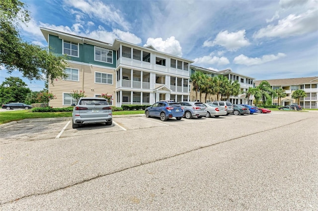 view of building exterior with uncovered parking