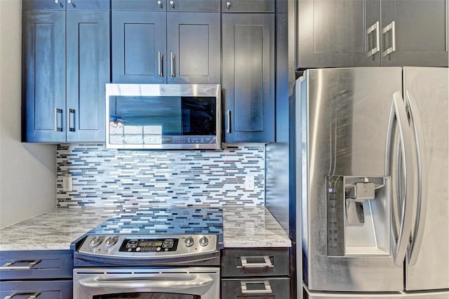 kitchen featuring appliances with stainless steel finishes, light stone countertops, and tasteful backsplash