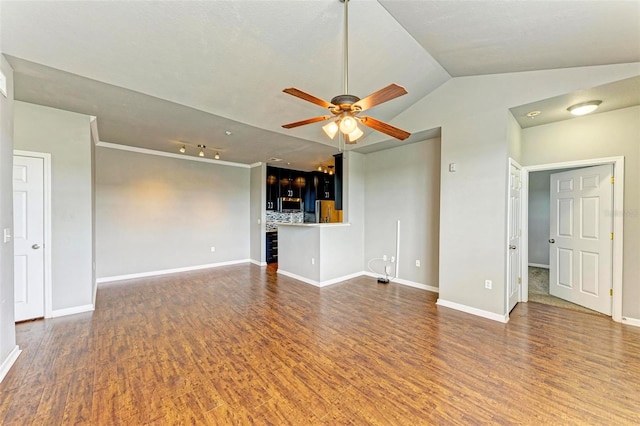 unfurnished living room with dark wood-style floors, lofted ceiling, baseboards, and a ceiling fan