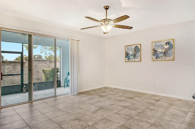 empty room with ceiling fan and light tile patterned floors