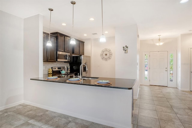 kitchen featuring decorative backsplash, light tile patterned flooring, appliances with stainless steel finishes, and dark brown cabinetry