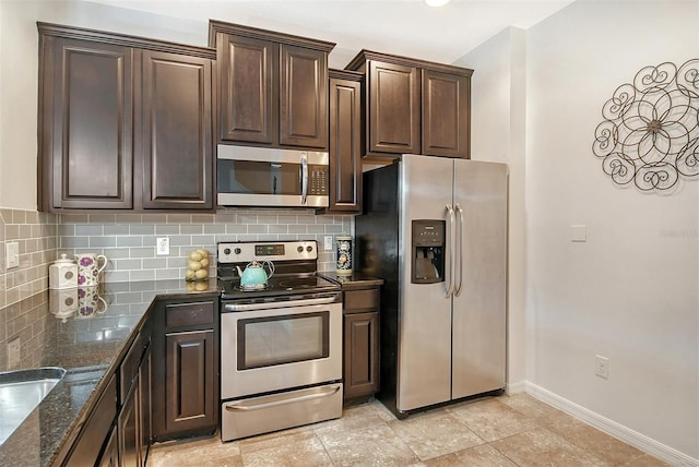 kitchen with appliances with stainless steel finishes, decorative backsplash, and light tile patterned flooring