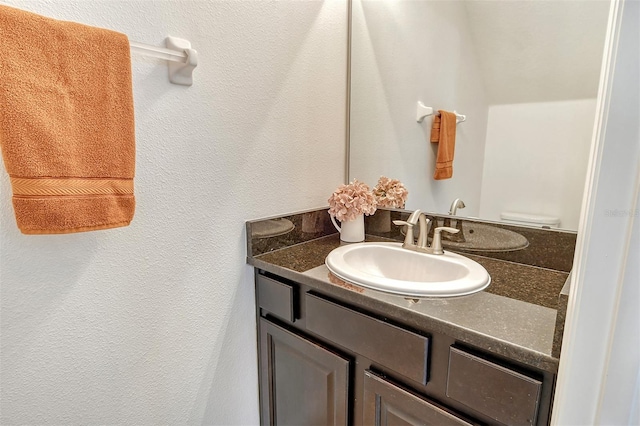 bathroom featuring toilet and vanity