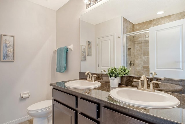 bathroom featuring an enclosed shower, toilet, and vanity