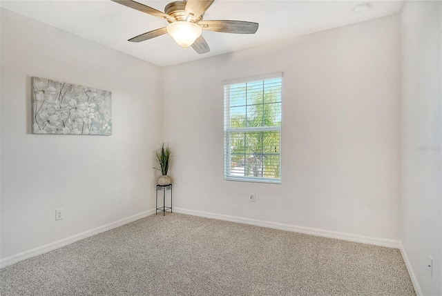 spare room featuring ceiling fan and carpet floors