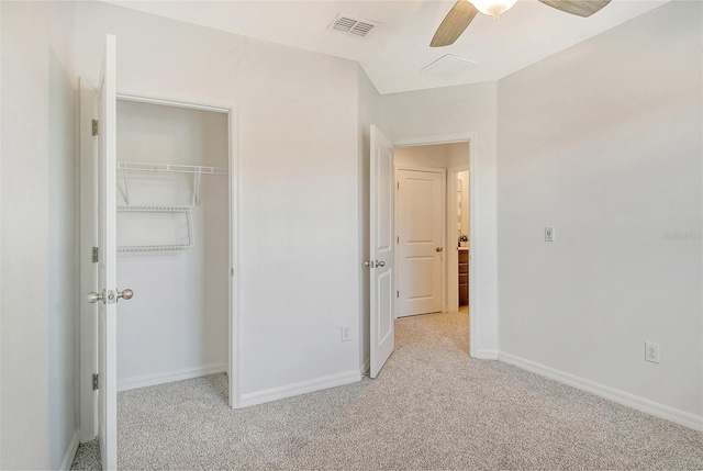 unfurnished bedroom with a closet, ceiling fan, and light carpet