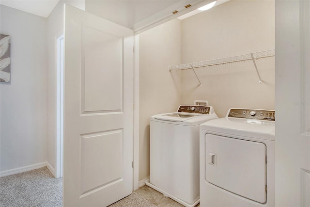 laundry room featuring light carpet and washing machine and clothes dryer