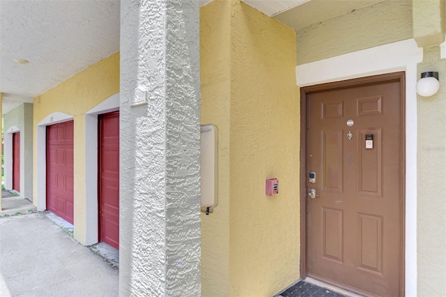 entrance to property featuring stucco siding