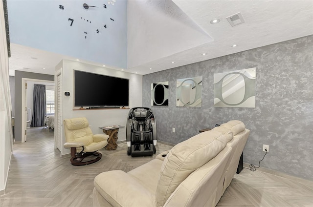 living room with recessed lighting, visible vents, baseboards, and wallpapered walls