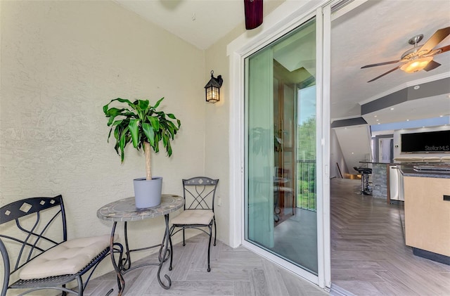 balcony with an outdoor kitchen and a ceiling fan