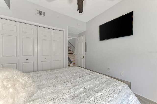 bedroom with a closet, visible vents, and a ceiling fan