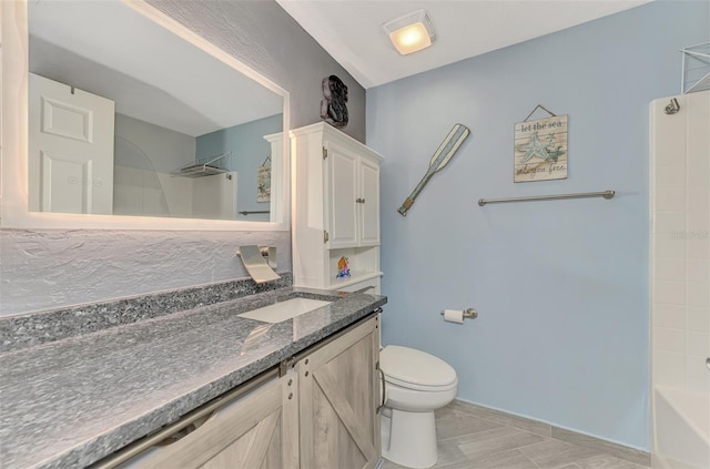 bathroom with shower / bathing tub combination, vanity, and toilet