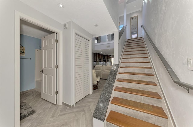 stairs featuring recessed lighting and baseboards