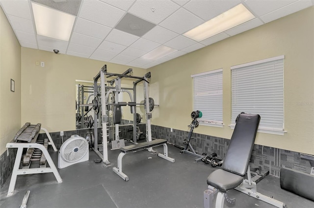 workout area featuring a paneled ceiling