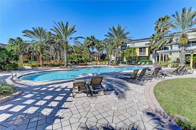 pool with a patio area and a pergola