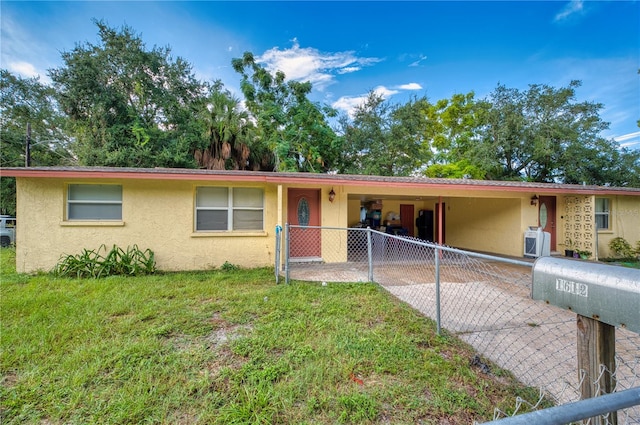 single story home with a front lawn and a carport