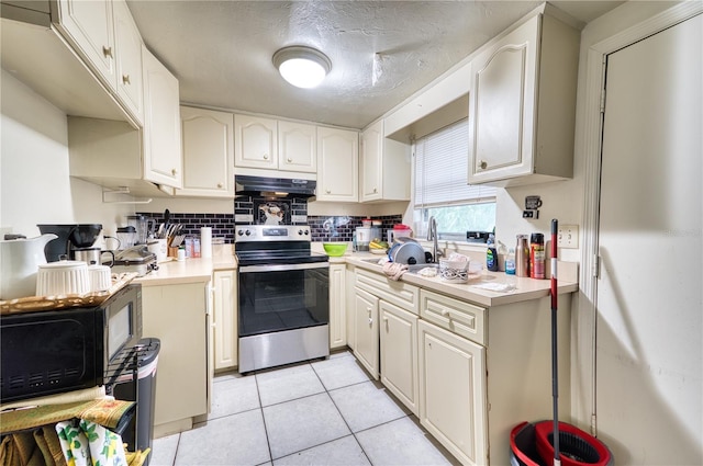 kitchen featuring white cabinets, stainless steel electric stove, light tile patterned floors, and tasteful backsplash