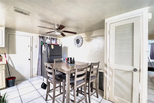 tiled dining room with ceiling fan