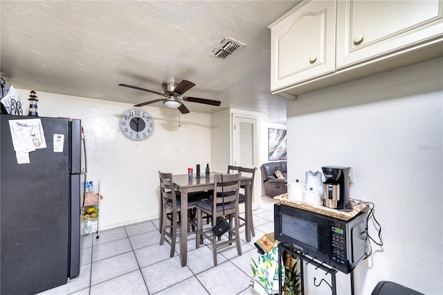 dining room with ceiling fan and light tile patterned flooring