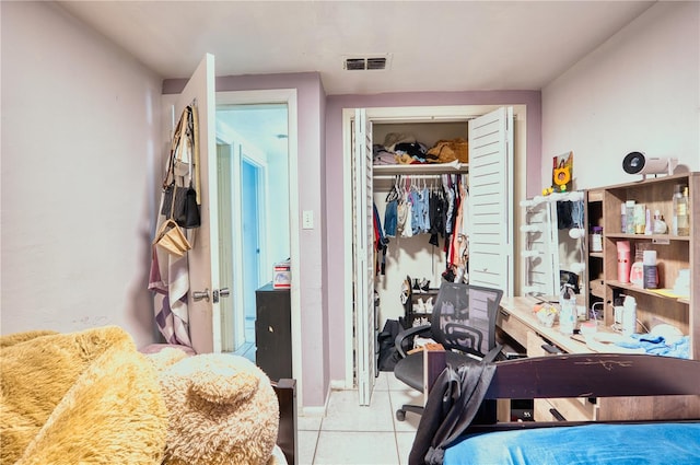 bedroom featuring light tile patterned floors and a closet