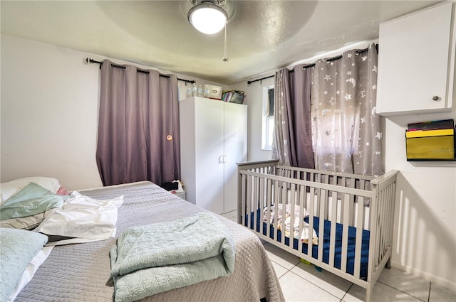 tiled bedroom with ceiling fan