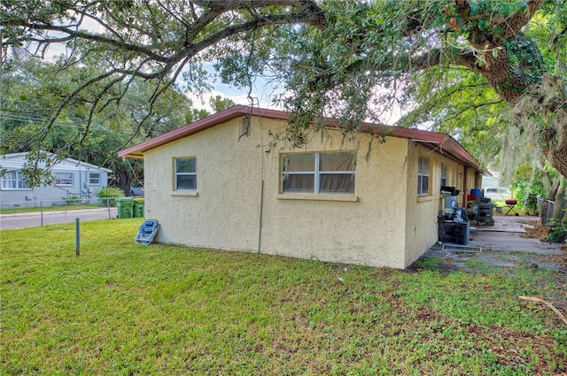 view of property exterior with a yard