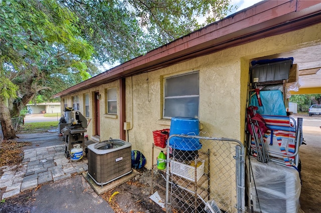 view of side of home featuring central AC