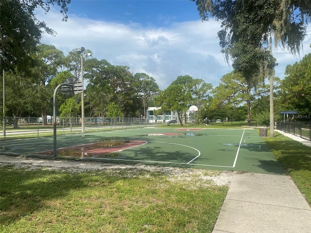 view of sport court featuring a yard