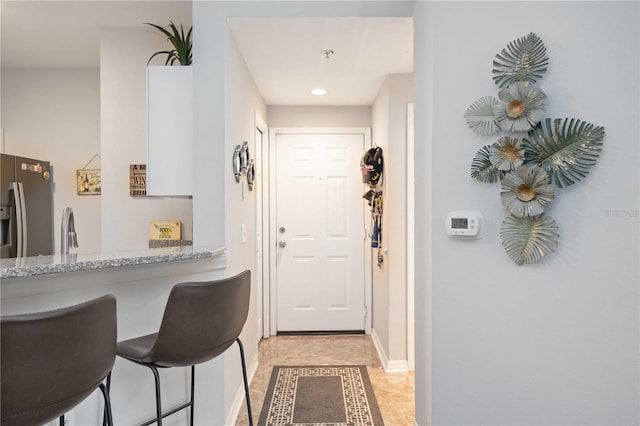 interior space with a sink and baseboards