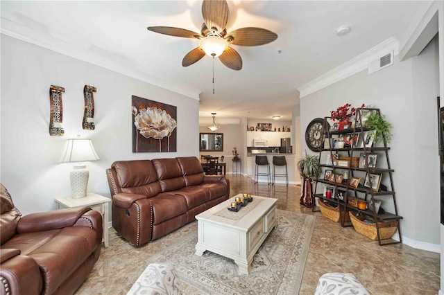 living area with baseboards, a ceiling fan, visible vents, and crown molding