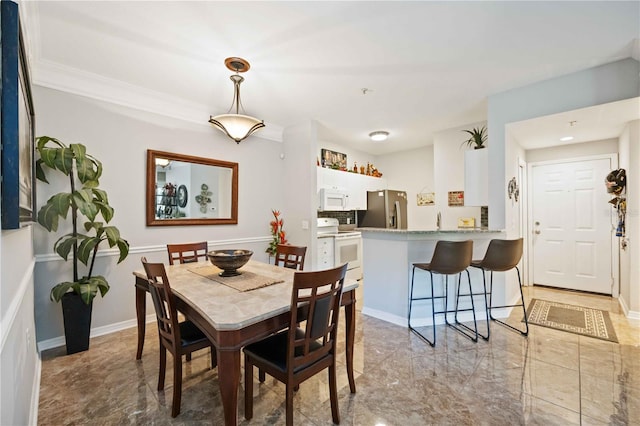 dining room featuring marble finish floor and baseboards