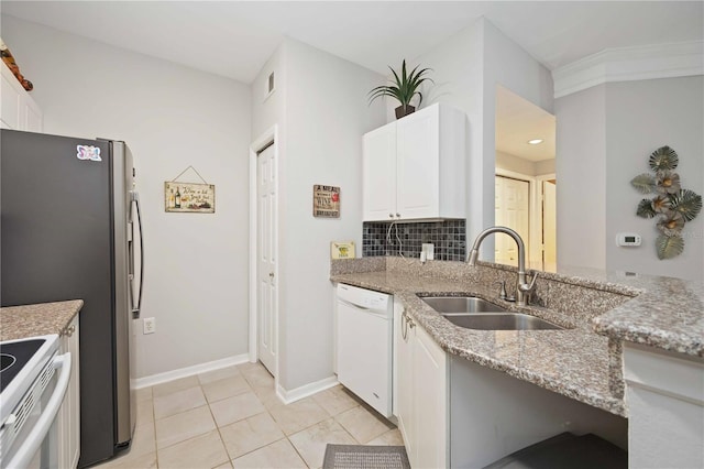 kitchen with white appliances, light stone counters, white cabinets, and a sink