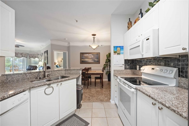 kitchen with white appliances, a sink, white cabinetry, and pendant lighting