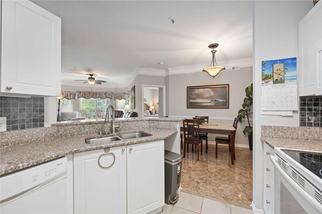 kitchen with light tile patterned flooring, backsplash, sink, white dishwasher, and white cabinetry