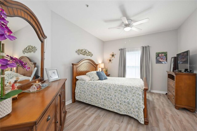 bedroom with light hardwood / wood-style floors and ceiling fan