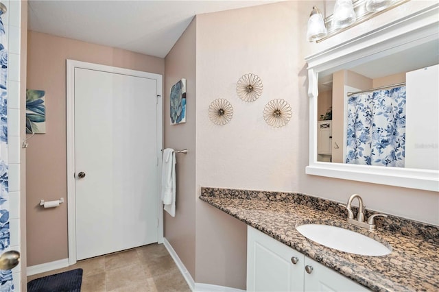 bathroom featuring baseboards and vanity