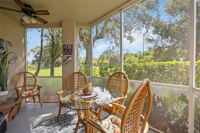 sunroom / solarium featuring ceiling fan