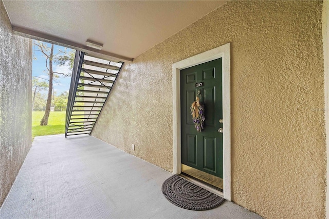 entrance to property featuring stucco siding