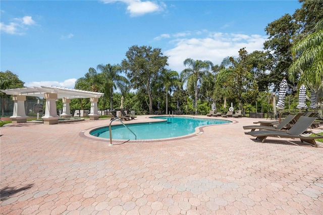 view of pool with a pergola and a patio